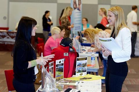 Two people talking at a career fair